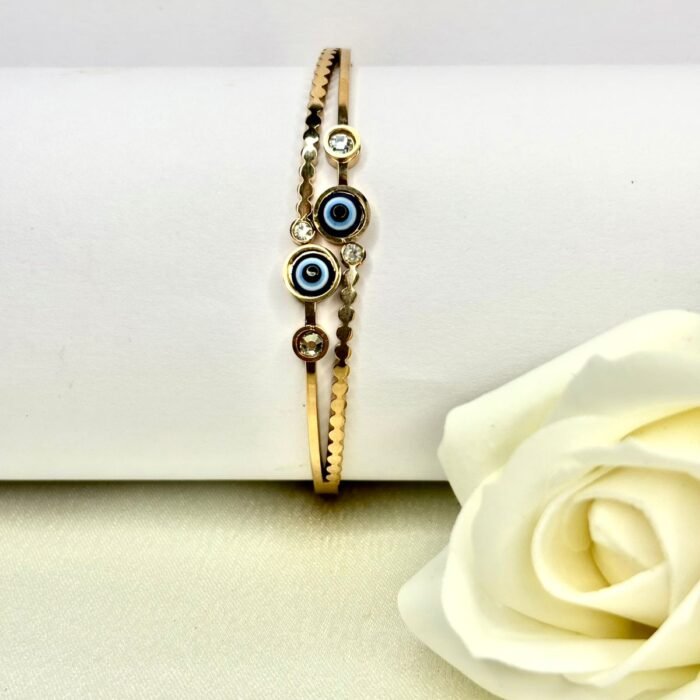 Golden coloured bracelet with two blue evil eye charms